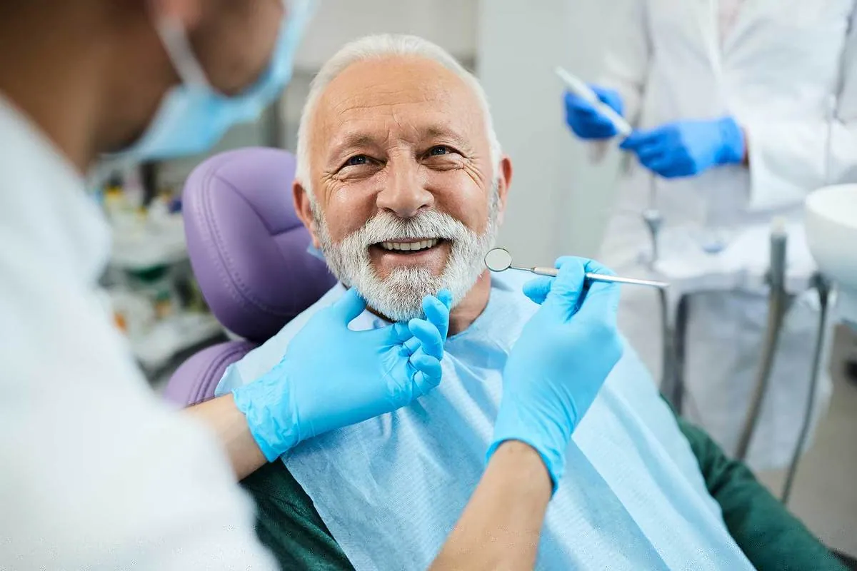 Elderly patient smiling during a dental checkup at Akeela Dental Care